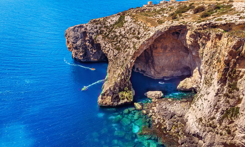 Explore Malta's Blue Grotto during leisure time on an overnight port stay in Valetta.