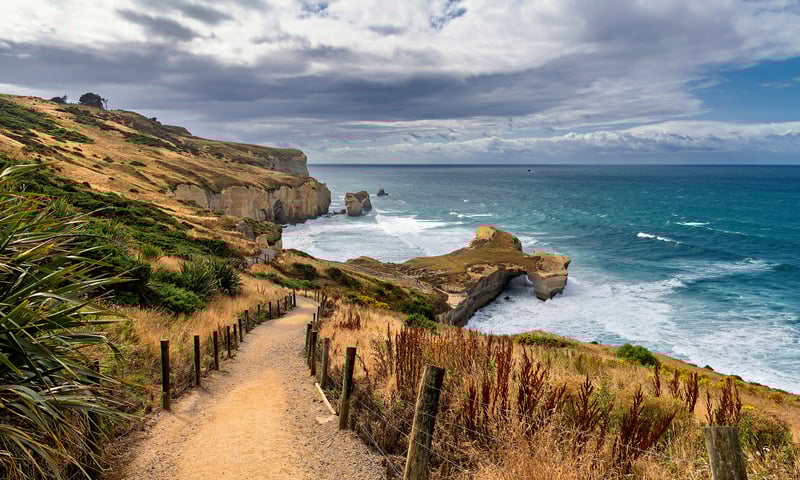 Stop at Tunnel Beach while docked in Dunedin.