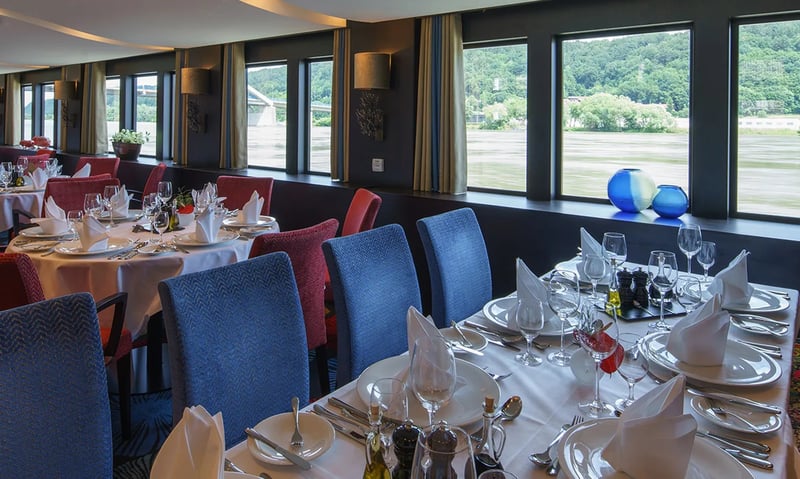 Take a window seat while enjoying a meal onboard your AmaStella ship.