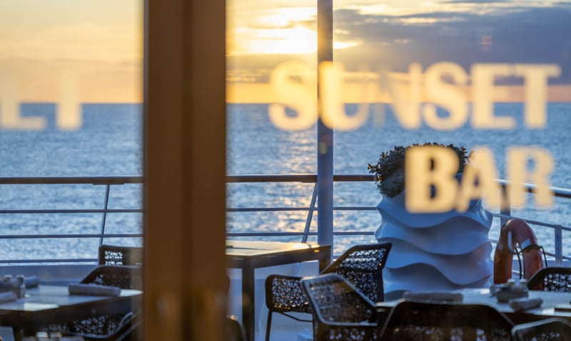 Socialise alfresco at the Sunset Bar aboard Azamara Pursuit.