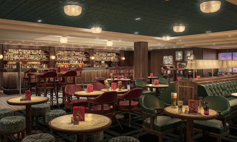 Make new friends at the Golden Lion Pub onboard Queen Anne.
