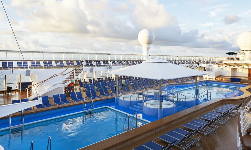 Relax under the summer sun on Norwegian Sun's pool deck.