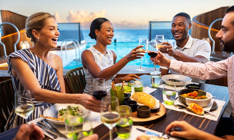 Dine with friends at Earth Ocean Restaurant overlooking the pool aboard Seabourn Venture.