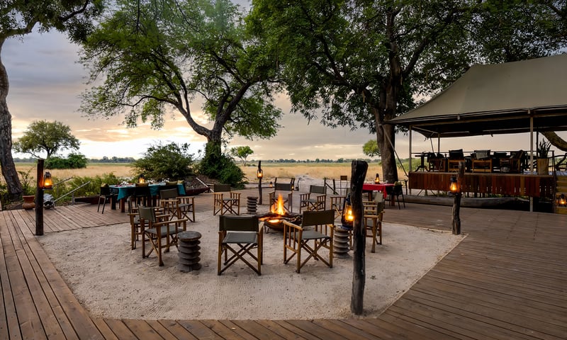 Unwind by the campfire after a day of wildlife viewing, Botswana's Kadizora Camp, or similar.
