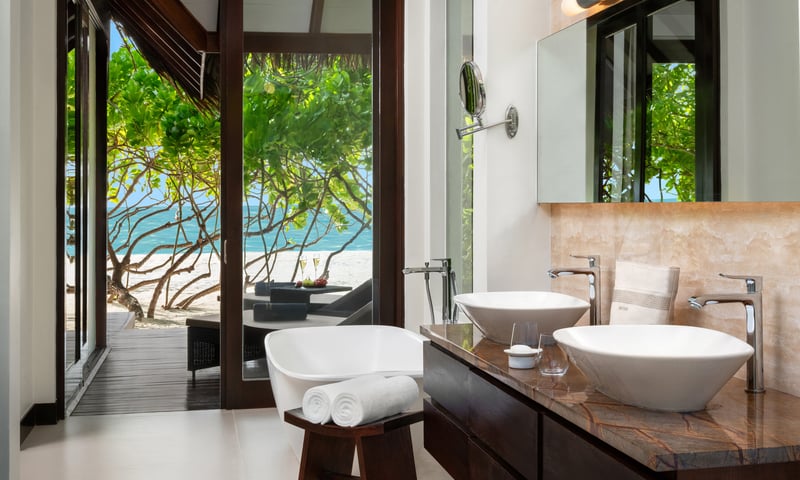 Beach Villas feature a spacious en-suite bath with an outdoor, tropical shower bathroom.
