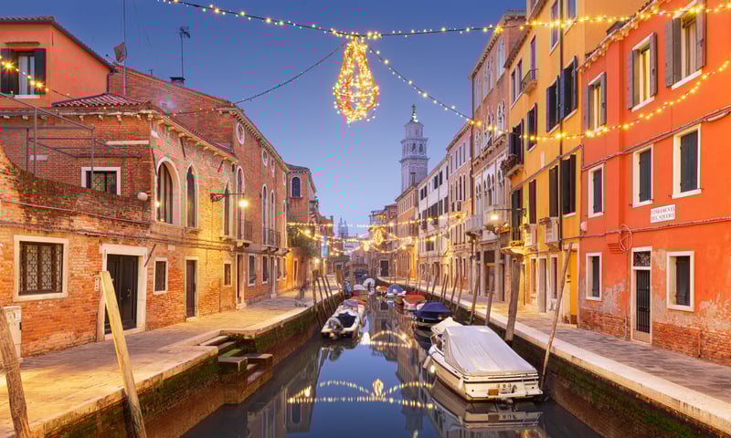 Spot Christmas lights over the canals in Venice, Italy.