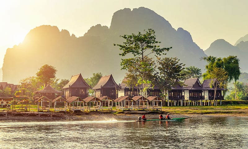 Unwind with a boat cruise on the Nam Song River to soak in the tranquil beauty of sunset, Vang Vieng